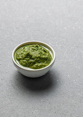 green coriander chutney in a white bowl