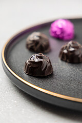 homemade dark chocolates served on a plate 