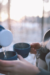 tea from a thermos in the forest