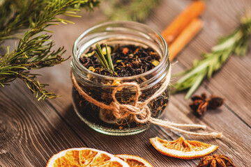 Brewing black tea with cinnamon, orange, rosemary and candied fruit. Mix for mulled wine. Tea composition.