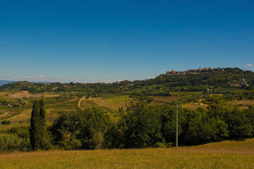 Obraz premium The late summer landscape around Montepulciano in Val d'Orcia, Siena Province, Tuscany, Italy. Montepulciano can be seen in the background right 