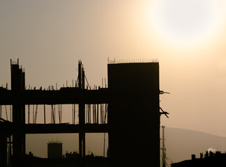 Silhouette of building columns under construction