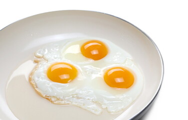 Fried eggs on frying pan isolated on white background