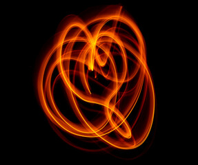 Light wave trail path, vibrant neon gold color in abstract swirls on a black background