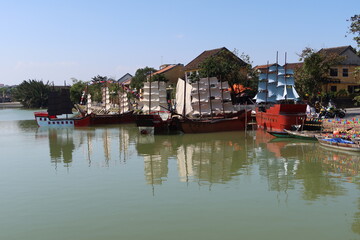 Fototapeta na wymiar Hoi An, Vietnam, January 16, 2021: Old boats for the Hoi An show anchored in the Thu Bon river