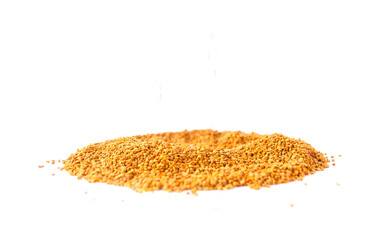 Crumbled bee pollen granules on white background.