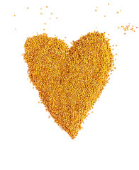 Bee pollen granules crumbled in the shape of heart on white background