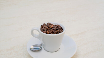 Coffee cup and beans on a white background. Top view with copy space for your text