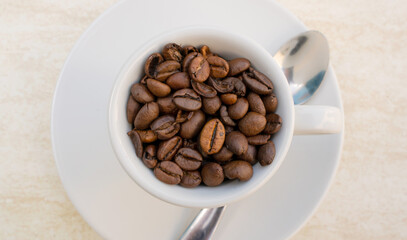 Coffee cup and beans on a white background. Top view with copy space for your text