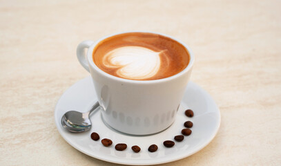 Background image of cappuccino in a cup with coffee beans