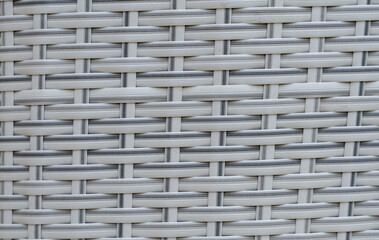 Black artificial rattan pattern. Background of basket structure close-up. Furniture backdrop backdrop