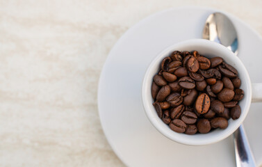 Coffee cup and beans on a white background. Top view with copy space for your text