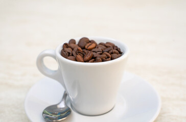Coffee cup and beans on a white background. Top view with copy space for your text