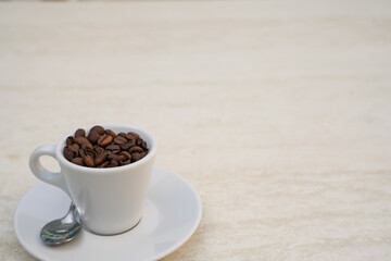 Coffee cup and beans on a white background. Top view with copy space for your text