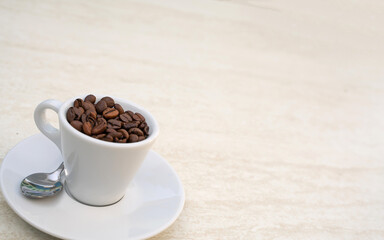Coffee cup and beans on a white background. Top view with copy space for your text