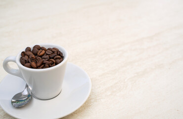 Coffee cup and beans on a white background. Top view with copy space for your text