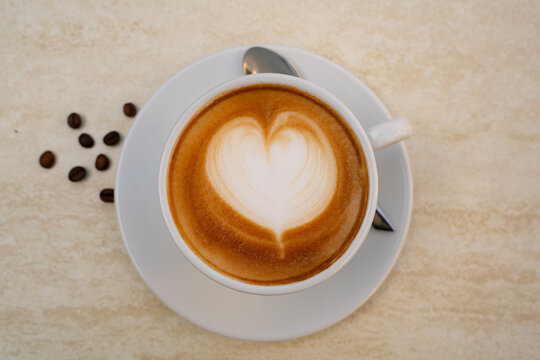 Background image of cappuccino in a cup with coffee beans