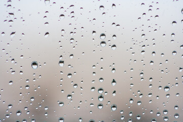 Drops of rain on the window or glass. Gray wet glass pattern texture. Abstract