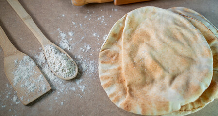 Kuboos or khubz - Arabic bread on a brown table in the kitchen