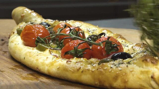 Preparing a traditional Turkish baked pide dish. Turkish pide pizza, Middle Eastern snacks. Turkish cuisine. Pide with meat filling.