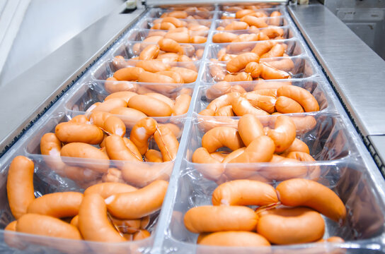 Sausages. Packing line of sausage. Industrial manufacture of sausage products.
