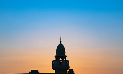 background image of mosque minaret during sunset