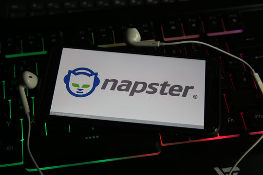 Viersen, Germany - January 9. 2021: Closeup of smartphone screen with logo lettering online music streaming service napster on computer keyboard