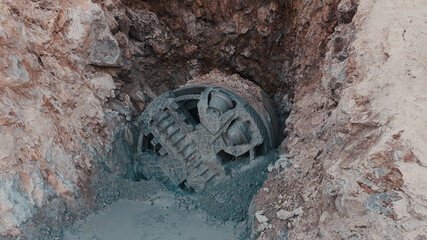 Close-up view of small tunnel boring machine on construction site. 
