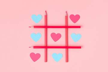 Tic-tac-toe with paper-cut hearts on a pink background. Different love of all colors. Blue and pink...