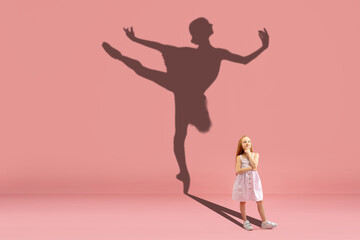 Fototapeta na wymiar Childhood and dream about big and famous future. Conceptual image with girl and drawned shadow of ballerina dancing on coral pink background. Childhood, dreams, imagination, education concept.