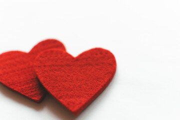 Red felt hearts on a white background. Valentine's Day