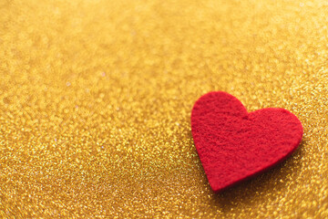 Red felt hearts on golden shiny background. Valentine's Day