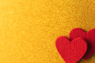 Red felt hearts on golden shiny background. Valentine's Day