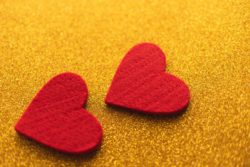 Red felt hearts on golden shiny background. Valentine's Day