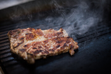 Slice of beef roasted on a barbecue grill