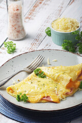 Omelette with ham and cheese on the plate