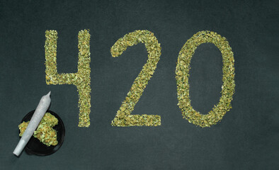 420 made with marijuana, joint and cannabis buds on black background. 420, expression of cannabis culture slang.