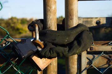 Old padlock on rusty shabby gate close up 
