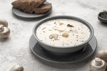 Vegan soup with mushrooms and coconut cream in a gray plate