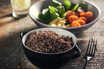 Soaked quinoa with sprouts and bowl of fresh vegetables and herbs