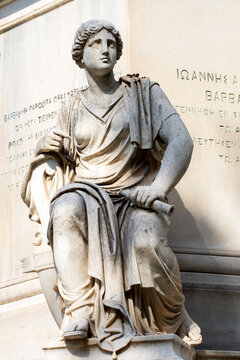 Marble statue on the base of the statue of Ioannis Varvakis in the garden of  Zappeion Palace of Athens, Greece. sunny day