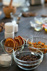 Group of bowls with coffee beans, dry fruits and flowers and other ingredients