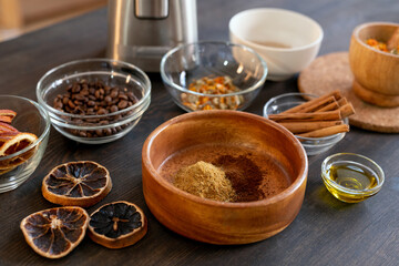 Obraz na płótnie Canvas Bowls with coffee beans, dry orange slices, cinnamon, ground candied fruits