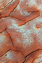 Texture of dry and cracked earth with striking colors on the banks of the Rio tinto.