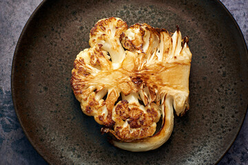 Cauliflower Steak on a dark plate