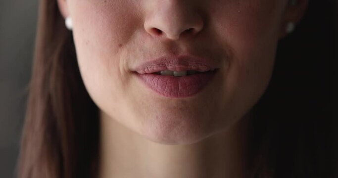 Close up view of lower female face part with plump lips talking, young caucasian woman speaking sharing ideas or life news, communicating or dictating text, saying words or whispering secret.