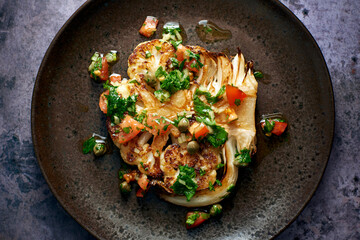 Cauliflower Steak on a dark plate