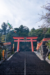 Higashimuro, Wakayama Prefecture / Japan, October 16 2020: Long flight of stairs leading up to a red Torii gate at Kumano Nachi Taisha Grand Shrine, and example of Japanese Shinto culture.