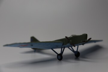 Model of an old green military aircraft from the Second World War on a white background....
