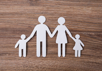 paper of family symbolizing on wooden background.
